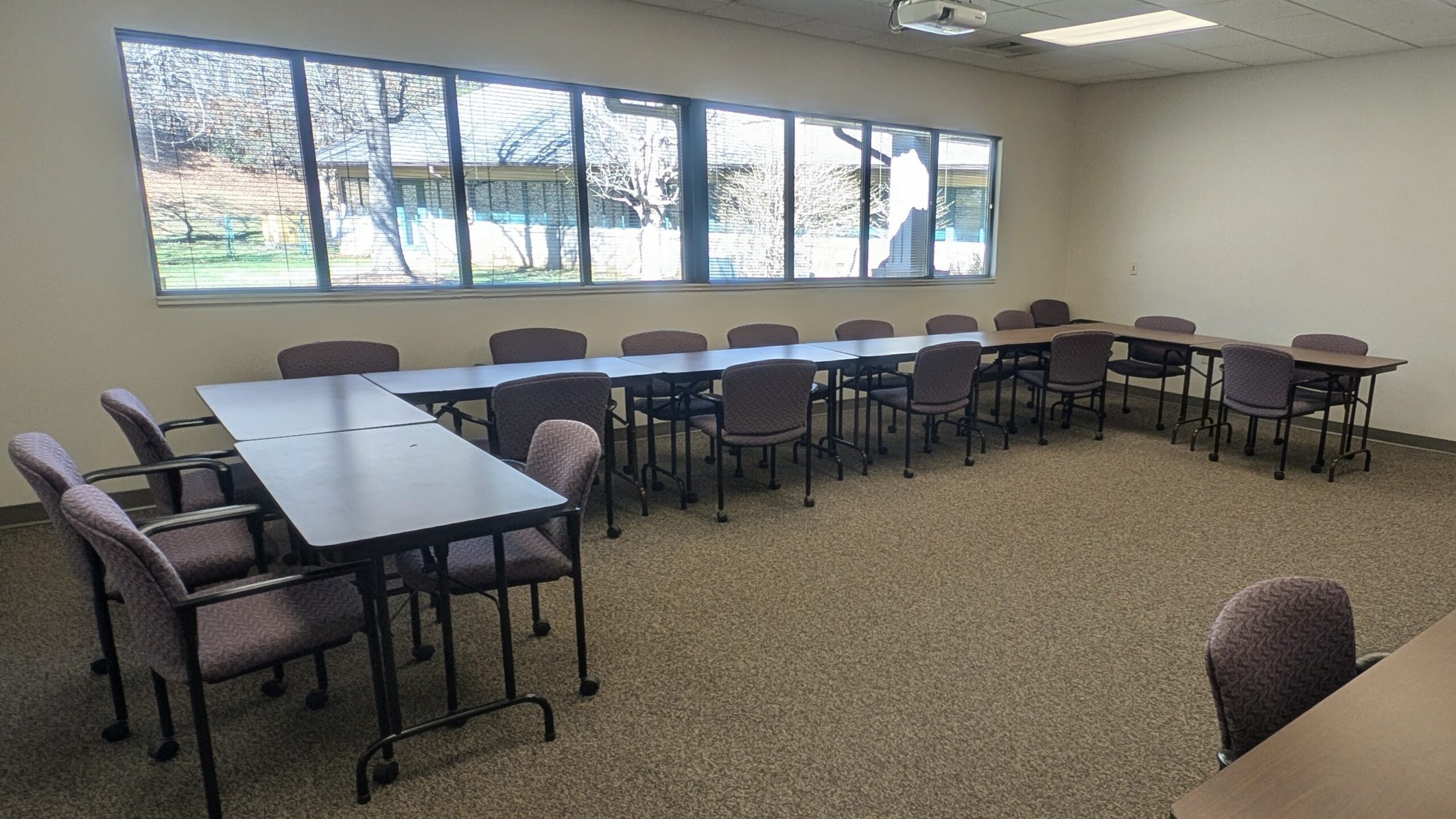 Photo of conference room containing tables and chairs for a meeting.